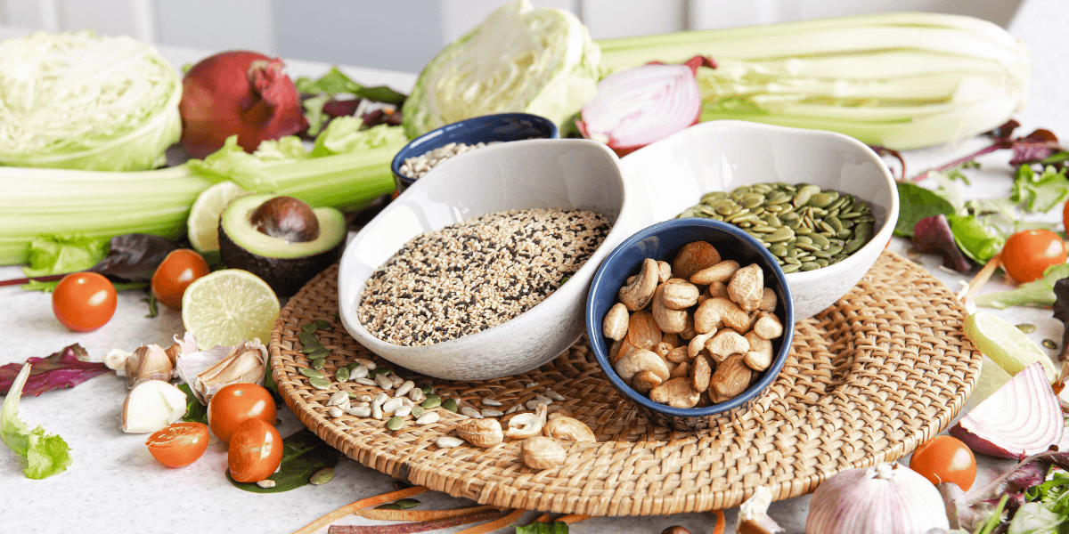 A table displays an assortment of various foods, including fruits, vegetables, and prepared dishes, inviting a communal meal.